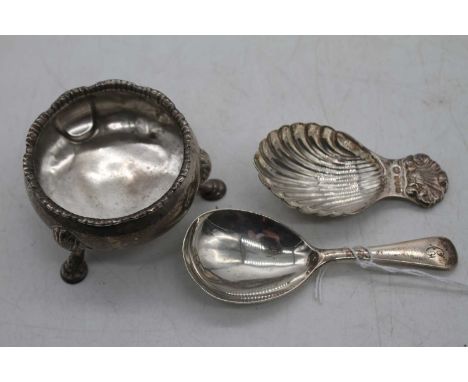 A George III silver open salt of squat circular form on cast feet, together with a silver caddy spoon having a shell shaped b