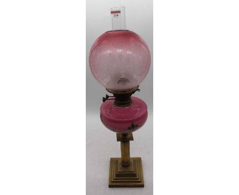 A Victorian brass oil lamp, the acid etched shade above a pink glass font and reeded stem, height 68cmSeveral tiny chips to t