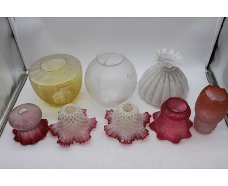 A collection of 19th century and later glass oil lamp shadesTwo floral white with cranberry frill – both with some minor chip