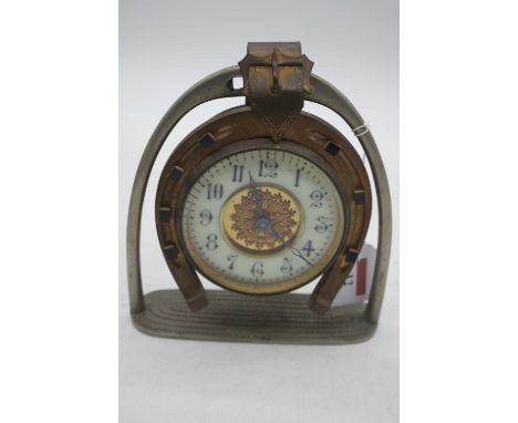 An early 20th century brass horseshoe clock, the enamel chapter ring showing Arabic numerals, height 15cm, later mounted to a