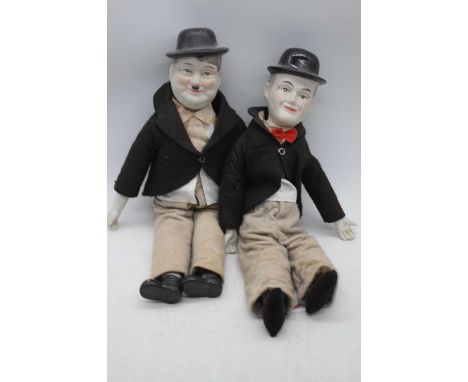 A pair of vintage bisque headed Laurel &amp; Hardy dolls, largest height 47cm