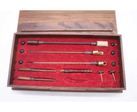 A mid-19th century Garrison Gun ramrod and ammunition, housed in a later oak display case, w.28cm 