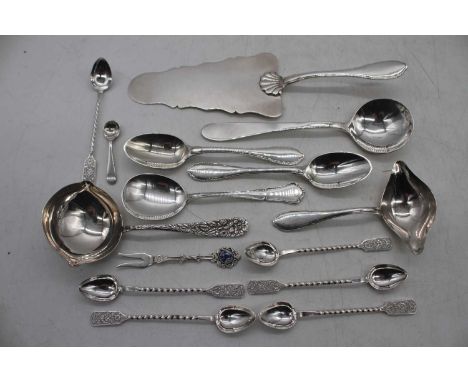 A mixed lot of 19th century and later continental white metal and silver plate flatware to include cake slice, sauce ladles, 