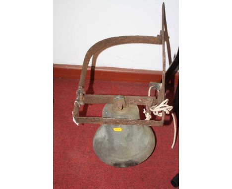 A vintage brass bell, on a wrought iron bracket, the bell height 23cm
