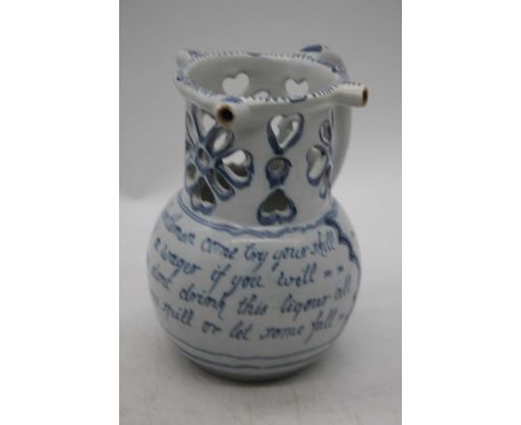 An 18th century Liverpool Delftware puzzle jug, h.18cmHas been restored to handle and rim.