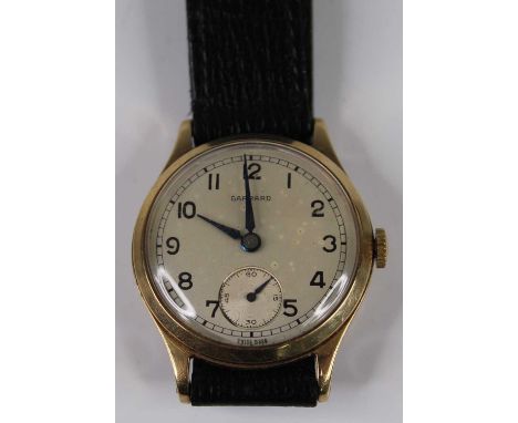 A Garrard gent's 9ct gold cased manual wind wristwatch, having signed silvered dial with subsidiary seconds dial, case dia. 3