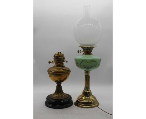 A Victorian brass oil lamp, height 61cm together with another, and spares