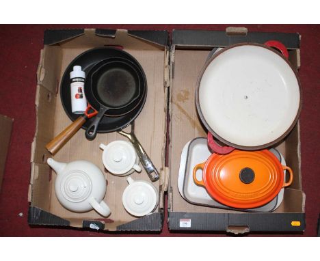 A collection of Le Creuset enamel cooking pans, dishes, and teawares