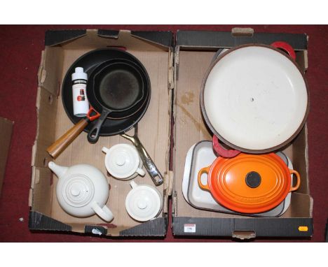 A collection of Le Creuset enamel cooking pans, dishes, and teawares