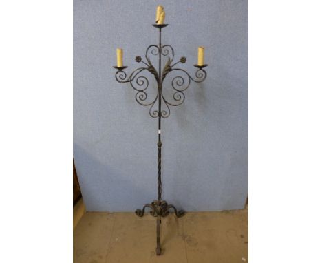A wrought iron standard lamp