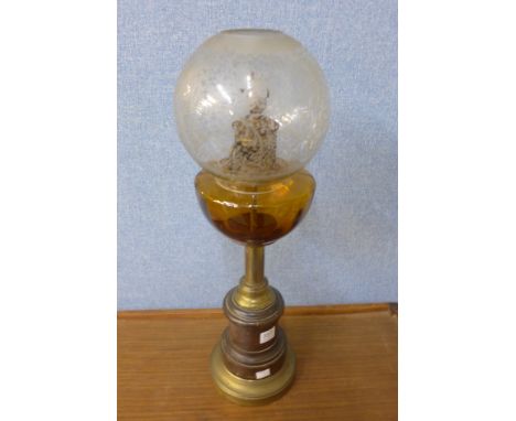 A mahogany and brass oil lamp
