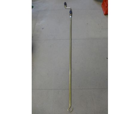 A brass sash window hook