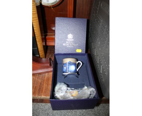 A BOXED ROYAL WORCESTER MILLENNIUM CUP AND SAUCER