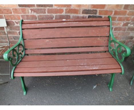 A GARDEN BENCH WITH CAST GREEN LEGS