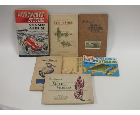A COLLECTION OF VINTAGE STAMPS, CIGARETTE CARDS ETC