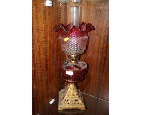 A VINTAGE PINK GLASS OIL LAMP AND SHADE