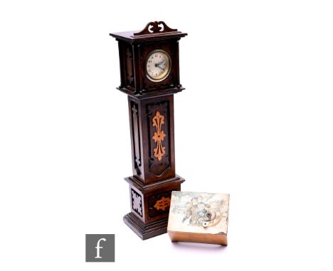 An Edwardian apprentice mahogany longcase clock, fitted with a circular Arabic dial over fret carved panels and sides on a st