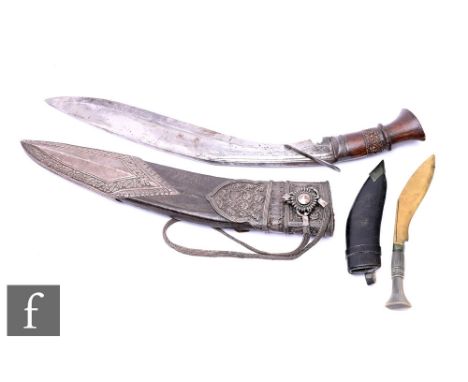 A late 19th Century kukri, carved handle, in silver mounted leather scabbard with strap handle, and a small throwing knife. (