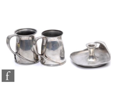 A pair of&nbsp;Archibald Knox for Liberty &amp; Co. pewter tankards of footed cylindrical section with whiplash split handle,