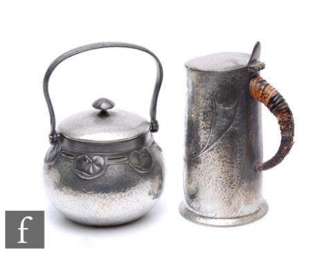 An early 20th Century&nbsp;Archibald Knox for&nbsp;Liberty &amp; Co pewter jug with a hinged cover and thumbpiece, moulded wi