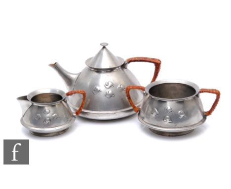 An early 20th Century&nbsp;Archibald Knox for Liberty &amp; Co. pewter tea set, comprising teapot, milk and sugar, with woven