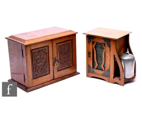 A late Victorian oak smoker's cabinet with fitted drawer interior enclosed by a pair of carved panel doors, width 36cm, anoth