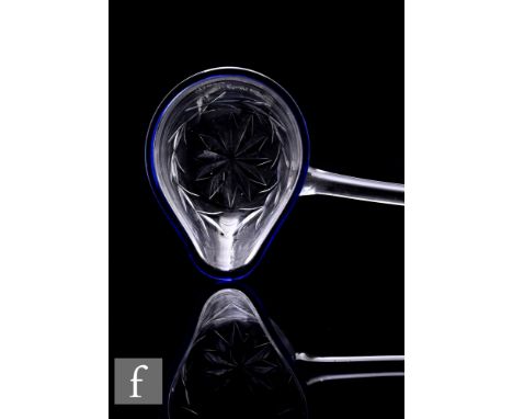 A late 19th Century clear crystal glass ladle, the cup bowl with spout decorated externally with a star cut and wreath design