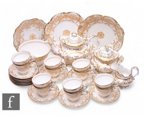 A John Ridgway teaset, circa 1840, gilt decorated with floral panels within trellis borders over white ground, comprising tea