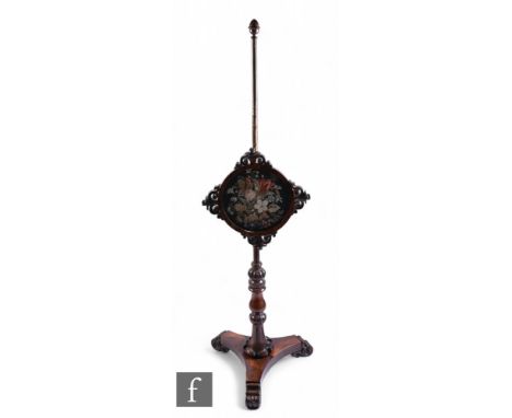 A 19th Century rosewood pole screen with circular floral tapestry panel and pierced scroll mounts on a turned pedestal and tr