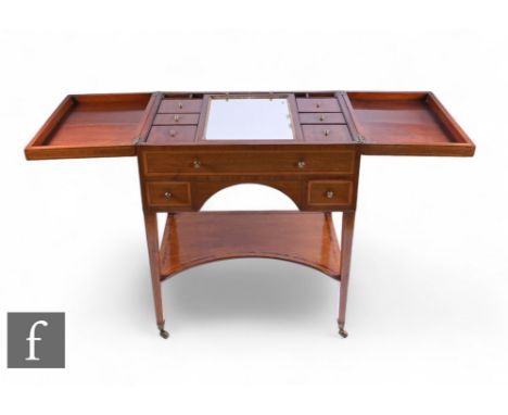 An Edwardian crossbanded and line inlaid dressing table, the double hinged top opening to reveal a compartmentalised interior
