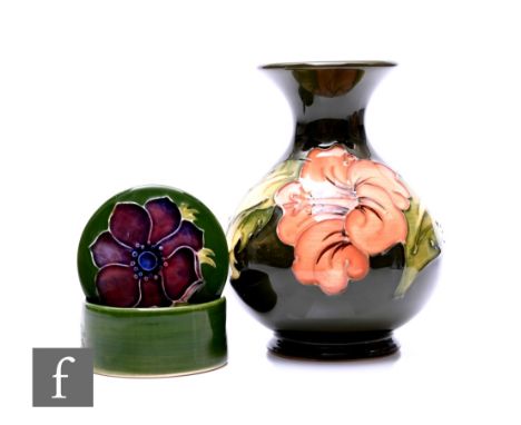 A Moorcroft Pottery Hibiscus pattern vase of ovoid form with drawn neck and everted rim, tubeline decorated with salmon glaze
