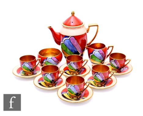 A Carlton Ware Handcraft Art Deco coffee set, painted with abstract fan pattern over brick red and salmon pink ground with gi