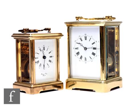 A late 19th Century French brass carriage clock, white enamelled dial striking on a gong, height 13cm, and a later smaller ca