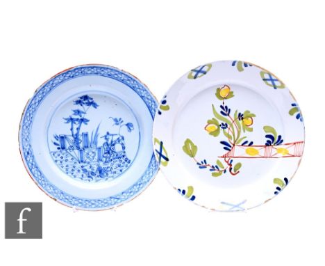 Two English delftware plates, circa 1730-60, one polychrome with a formal fence, the other in blue with a seated Chinese figu