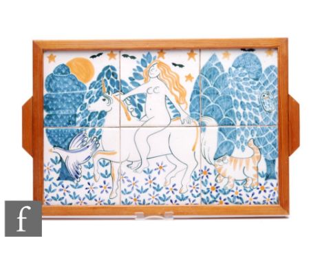 A framed later 20th Century tile panel formed from six 6 inch tiles, decorated with a female figure riding a unicorn in a woo