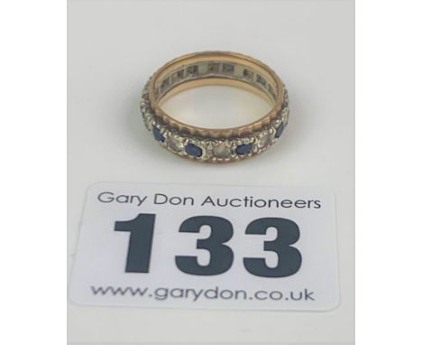Unmarked eternity ring with blue and white stones, size K, w: 3.1 gms