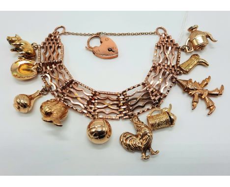 9 CARAT GOLD GATE BRACELET WITH MIXED GOLD CHARMS - APPROX 53 GRAMS