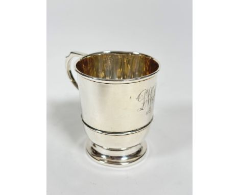 A Birmingham 1928 silver tapered cylinder christening cup with C scroll handle to side with engraved initials DWM 1929, (8cm 
