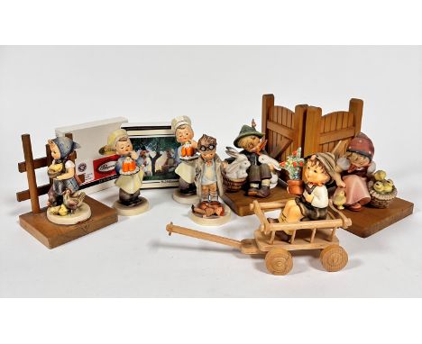 A pair of Hummel pottery mounted treen gate bookends, Boy with Rabbits and Girl with Chicks, (15cm x 11.5cm x 11cm), a Little
