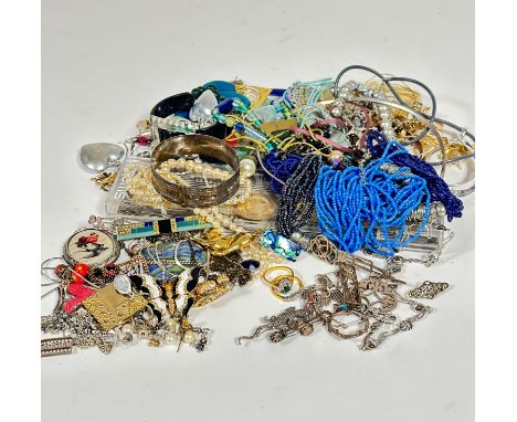 A large collection of costume jewellery including paste pearl necklaces, bead necklaces, thong style necklaces, a Swatch gold