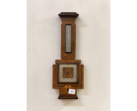 A quality early 20th century aneroid barometer and thermometer in a banjo pattern walnut, rosewood banded and ebony strung ca