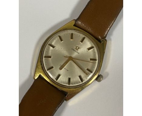 A Gents Omega yellow metal manual wind wristwatch, the silvered dial with applied baton markers, on replacement strap and buc