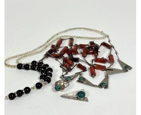 An opaque glass Deco style bead necklace with black glass beads, with paste set spacers, (L: 42cm), a hardstone carnelian rec