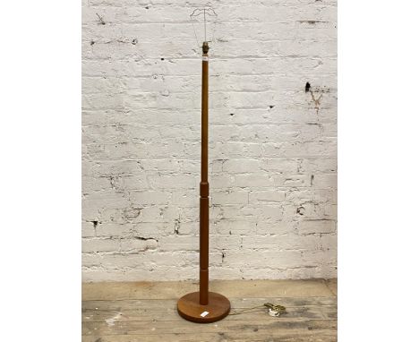 A mid century teak standard lamp, the turned and reeded stem on a circular base H141cm