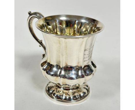 A George IV London 1836 silver baluster panelled christening mug with rococo style C scroll handle to side, on moulded base, 
