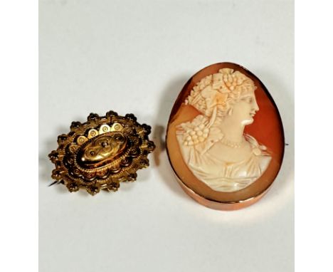 A 9ct gold oval carved shell cameo brooch with Grecian style carved portrait of a lady with grapes and leaves in her headdres