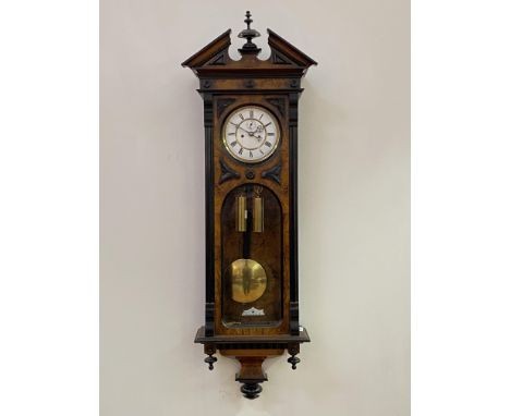 A Victorian figured walnut and ebonised Vienna regulator wall clock, the case of architectural form with broken arch pediment