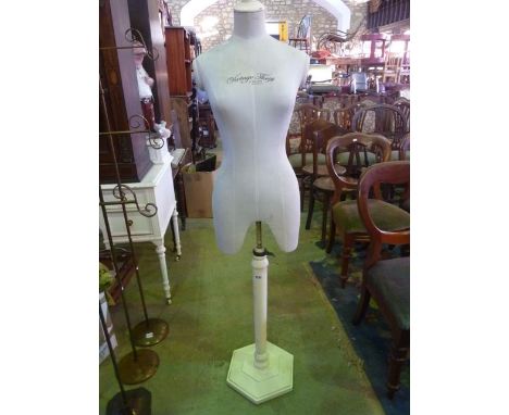 A shop display dummy, female torso, with printed lettering Vintage Thrift, raised on a painted stand with hexagonal faceted p