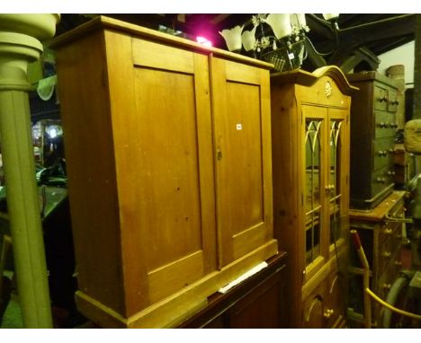 A 19th century stripped pine side cupboard enclosed by a pair of rectangular panelled doors, the interior fitted with a singl