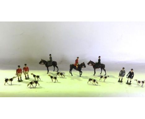 A vintage painted lead assembly of a hunting group comprising three riders on mounts, four standing figures and eight hounds